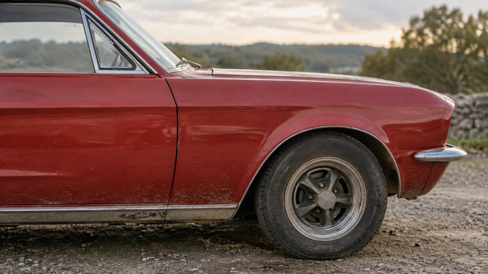 Faded red paint, a gravel lot and a little front vent window. Here is why that small piece of glass matters when you are sorting out a '68 from a '69 Camaro.